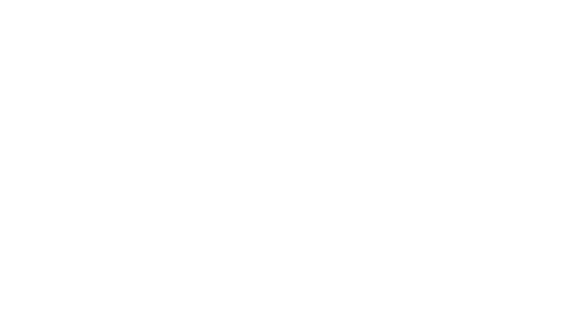 One person collecting the output of a machine while another sits unused