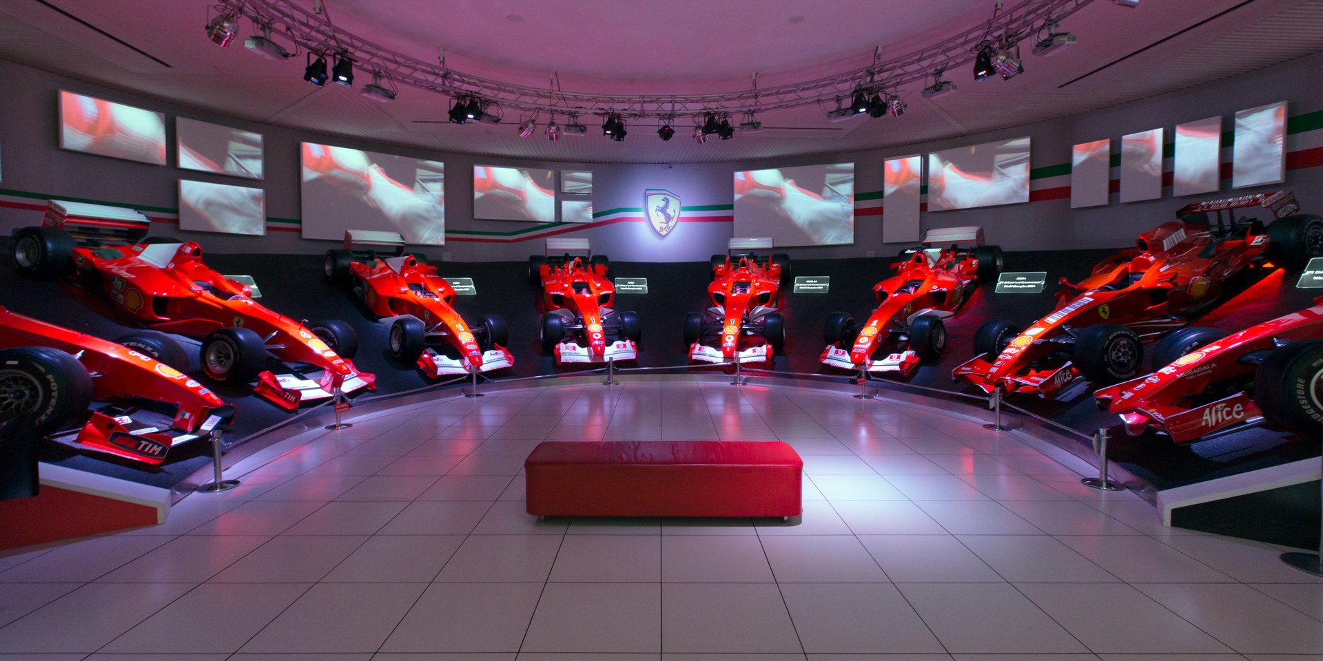 Line of championship-winning Ferrari Formula One cars in rosso corsa at Museo Ferrari