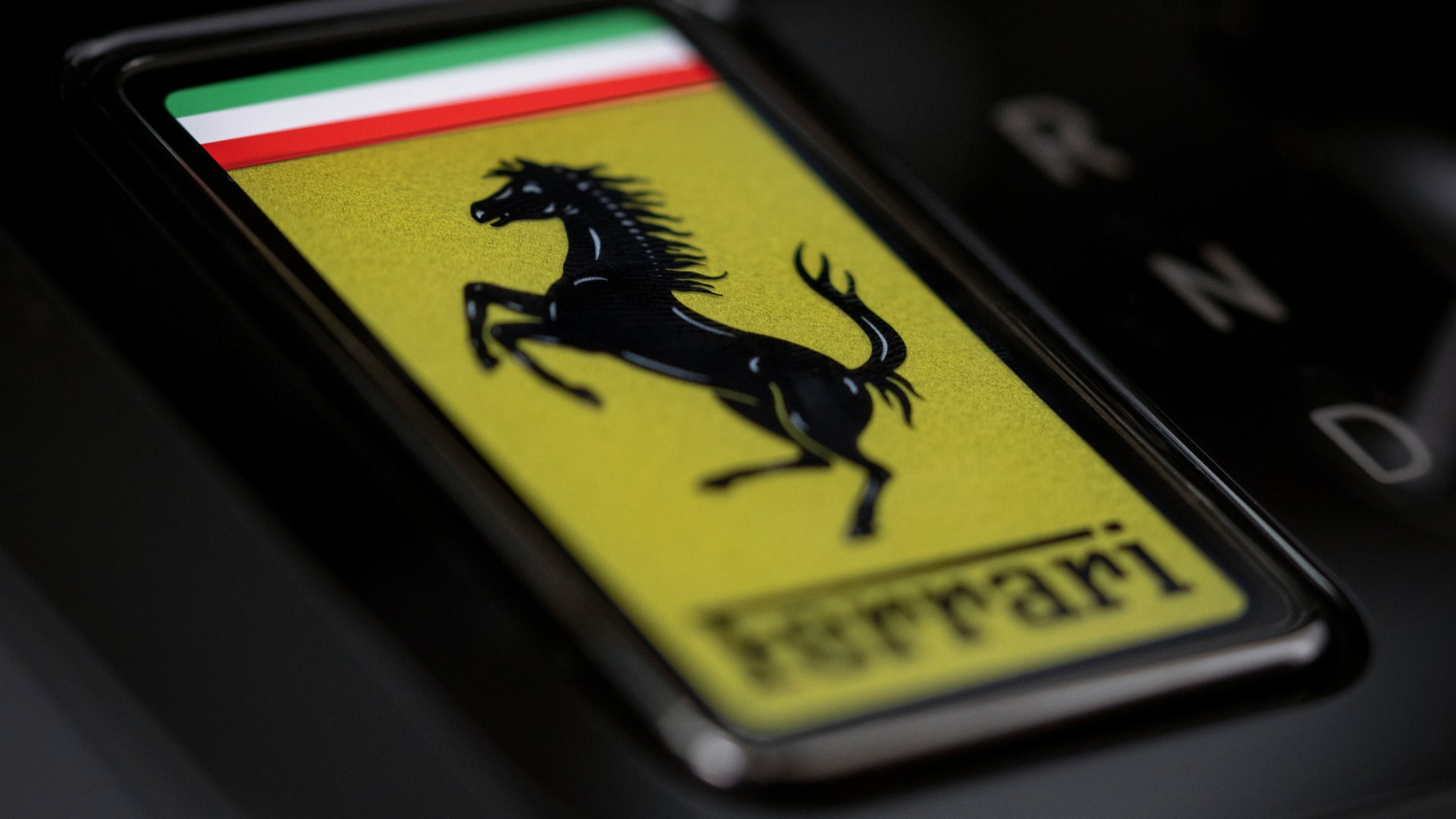 Ferrari prancing horse badge on yellow field inside the Luce cabin