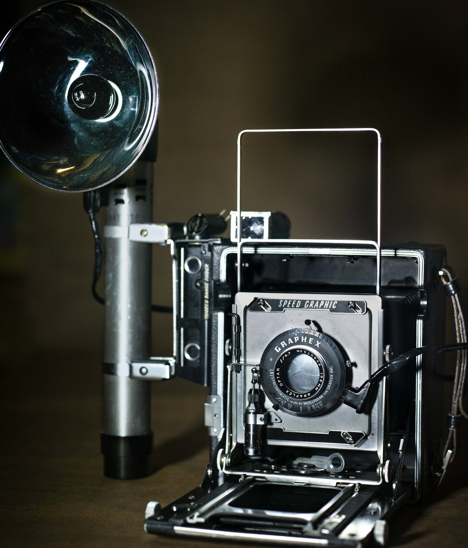 Graflex Speed Graphic press camera with cylindrical flash handle and chrome reflector