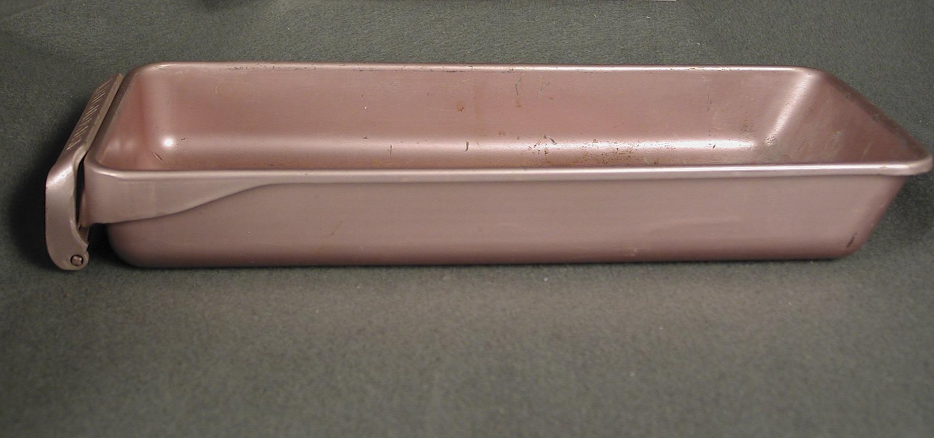Anodized aluminum ice cube tray with a hinged release lever, grid removed, from Julia Child’s kitchen