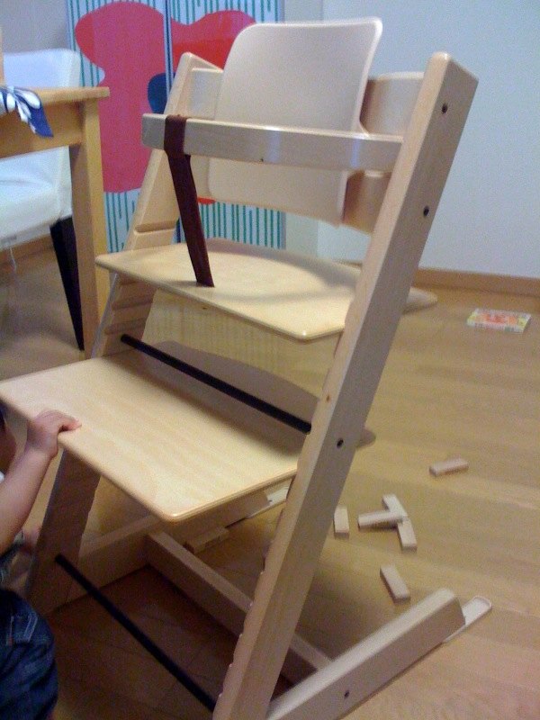 Wooden Stokke Tripp Trapp high chair with adjustable seat and footrest